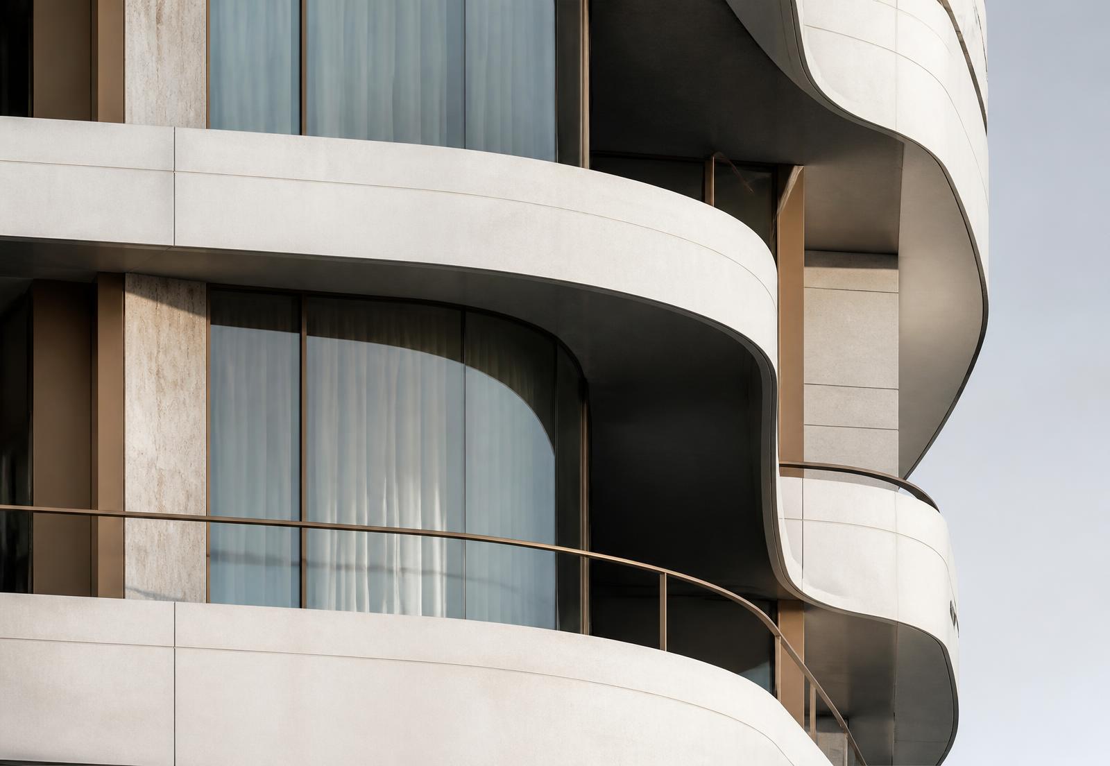 Concept detail of curved stone balcony edges and bronze glazing